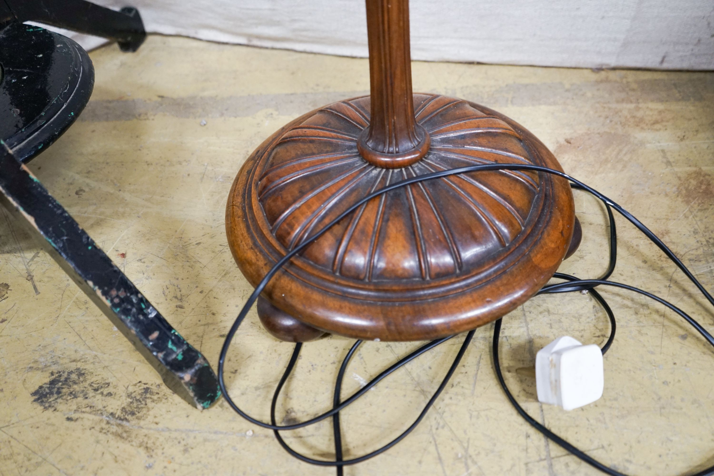 A turned and carved walnut standard lamp on circular base with bun feet, height excluding shade 132cm